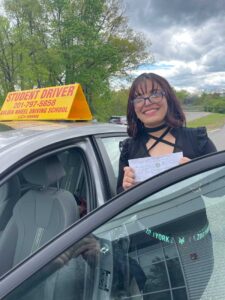 Student next to driving school car