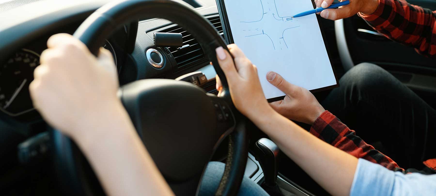 woman-and-man-with-checklist-driving-school-78XWWYU.jpg